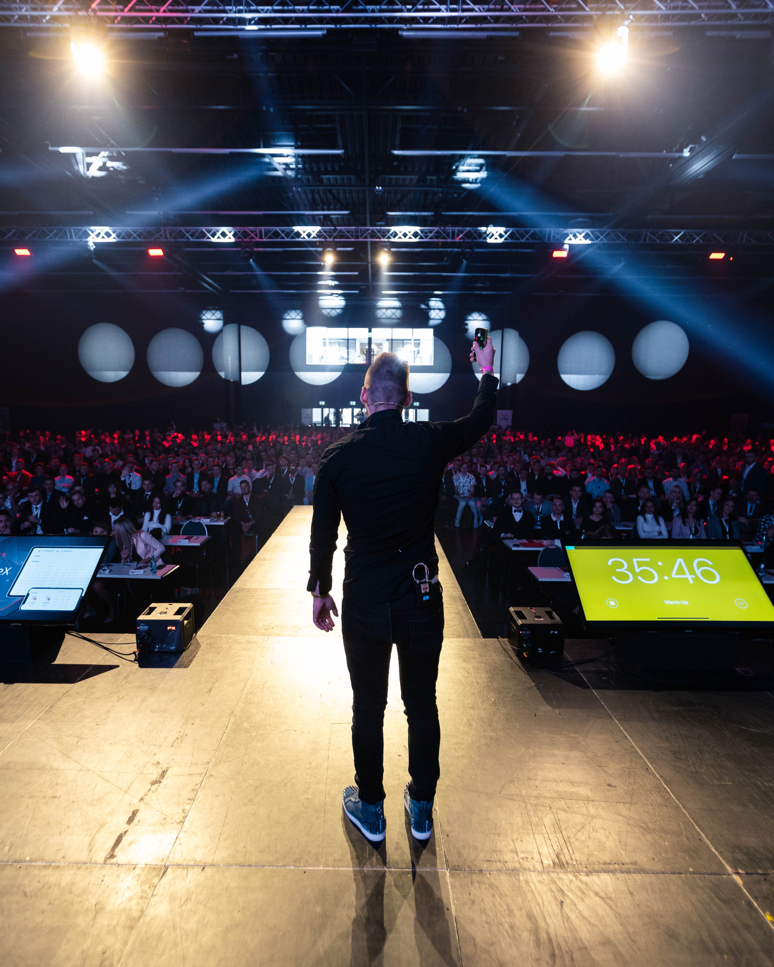 Andreas Vezonik on stage in front of a large audience
