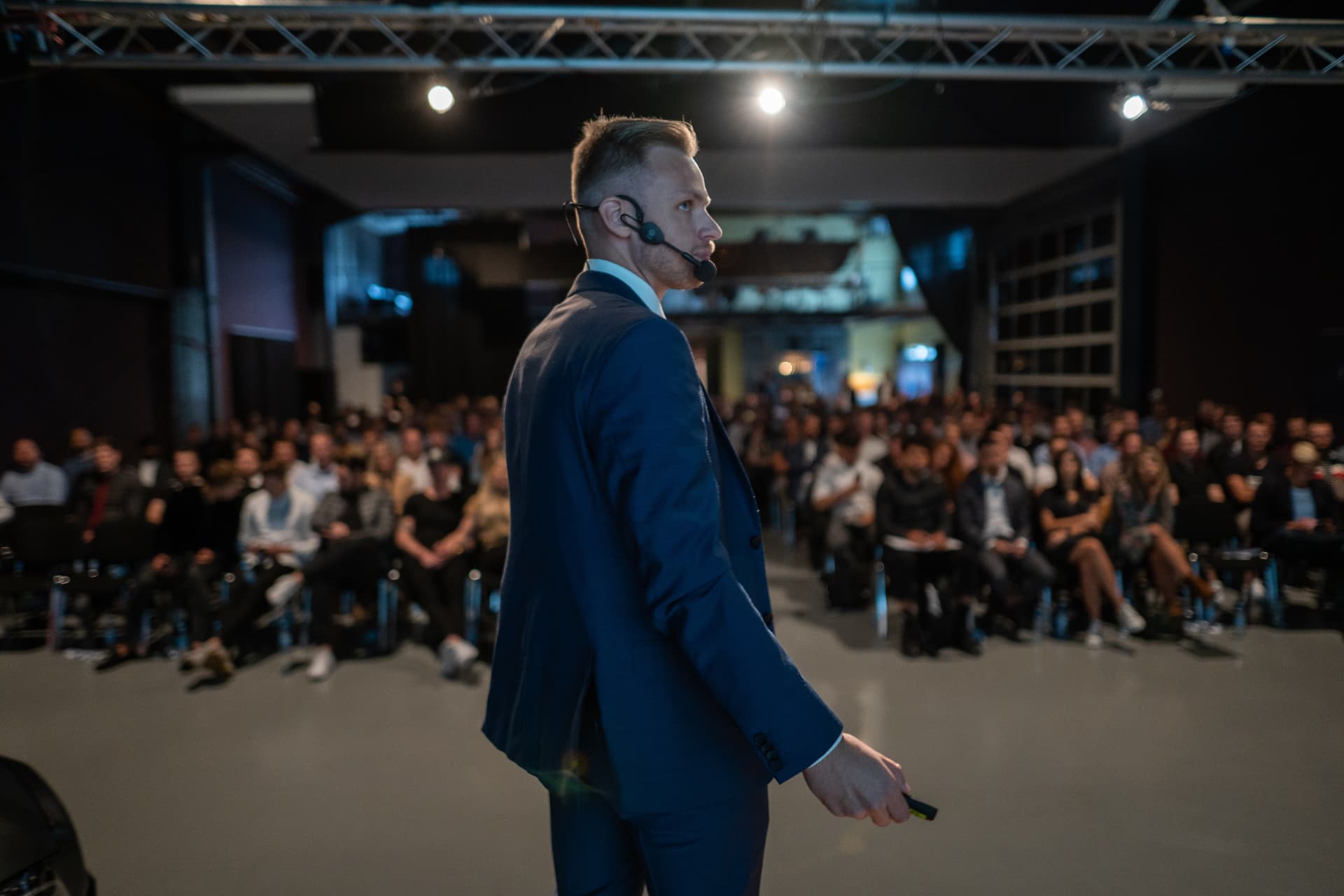 Andreas Vezonik on stage in front of a conference audience